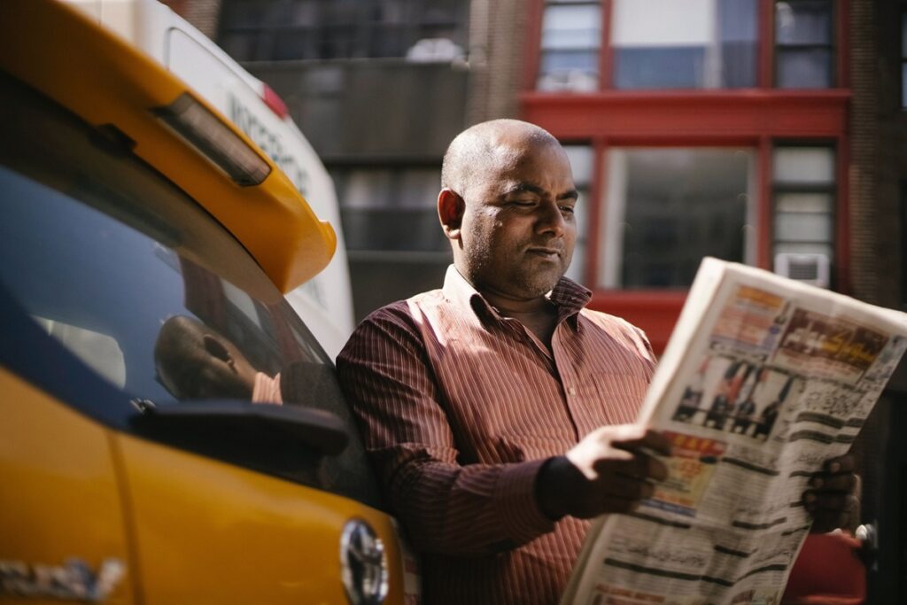 Taxi Driver reading a newpaper