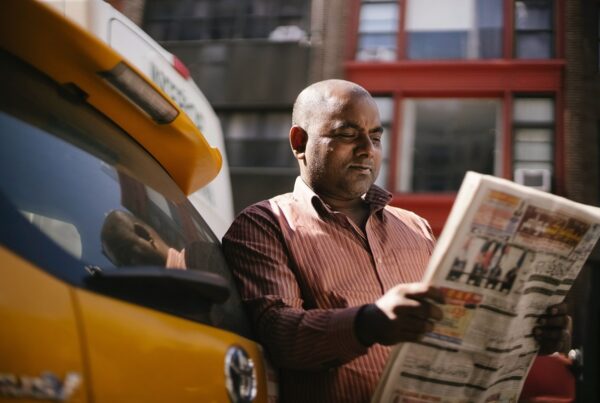 Taxi Driver reading a newpaper
